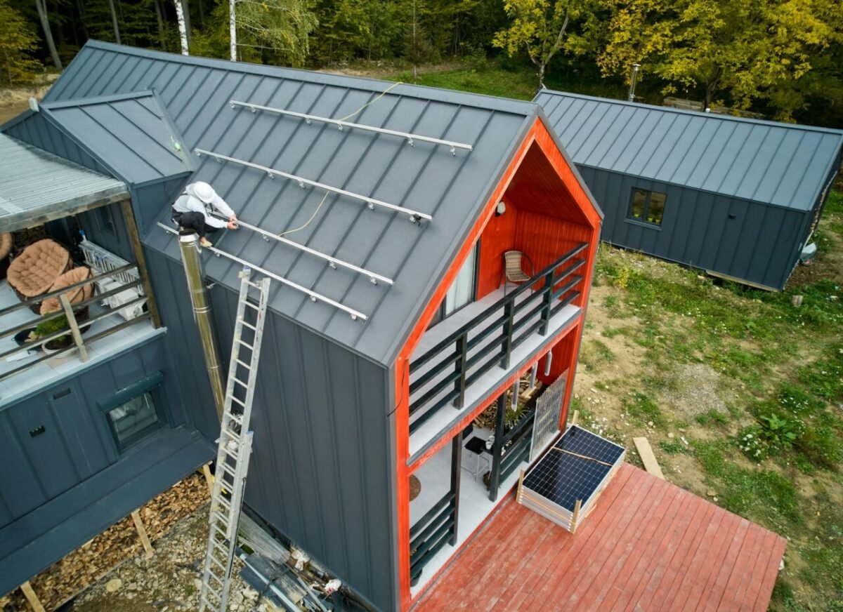 man-worker-prepearing-for-mounting-photovoltaic-solar-modules-on-roof-of-house-e1726584797784.jpg